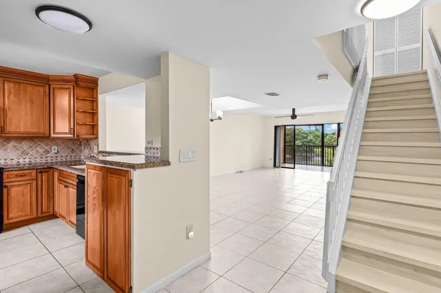 a view of a kitchen with granite countertop cabinets
