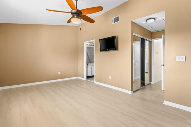 a bathroom with a granite countertop sink mirror vanity and toilet