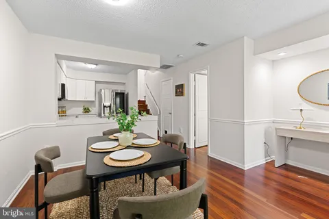 a living room with furniture and a kitchen view