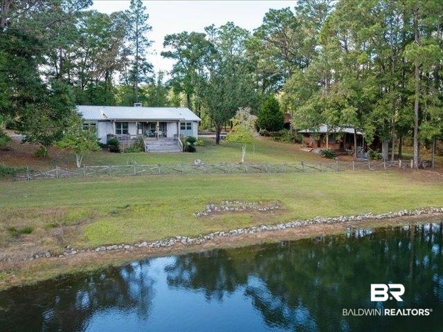4650 Wiggins Lane Wilmer, AL 36587 - Photo 51 of 66 Rear view of property featuring a water view and view of wooded area