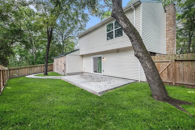 a view of a house with a backyard