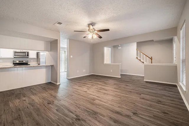 a view of a kitchen with wooden floor and a kitchen