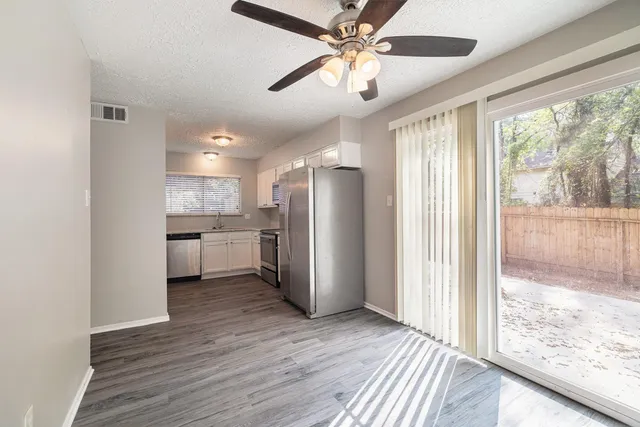 a view of a kitchen with a stove cabinets and a wooden floor