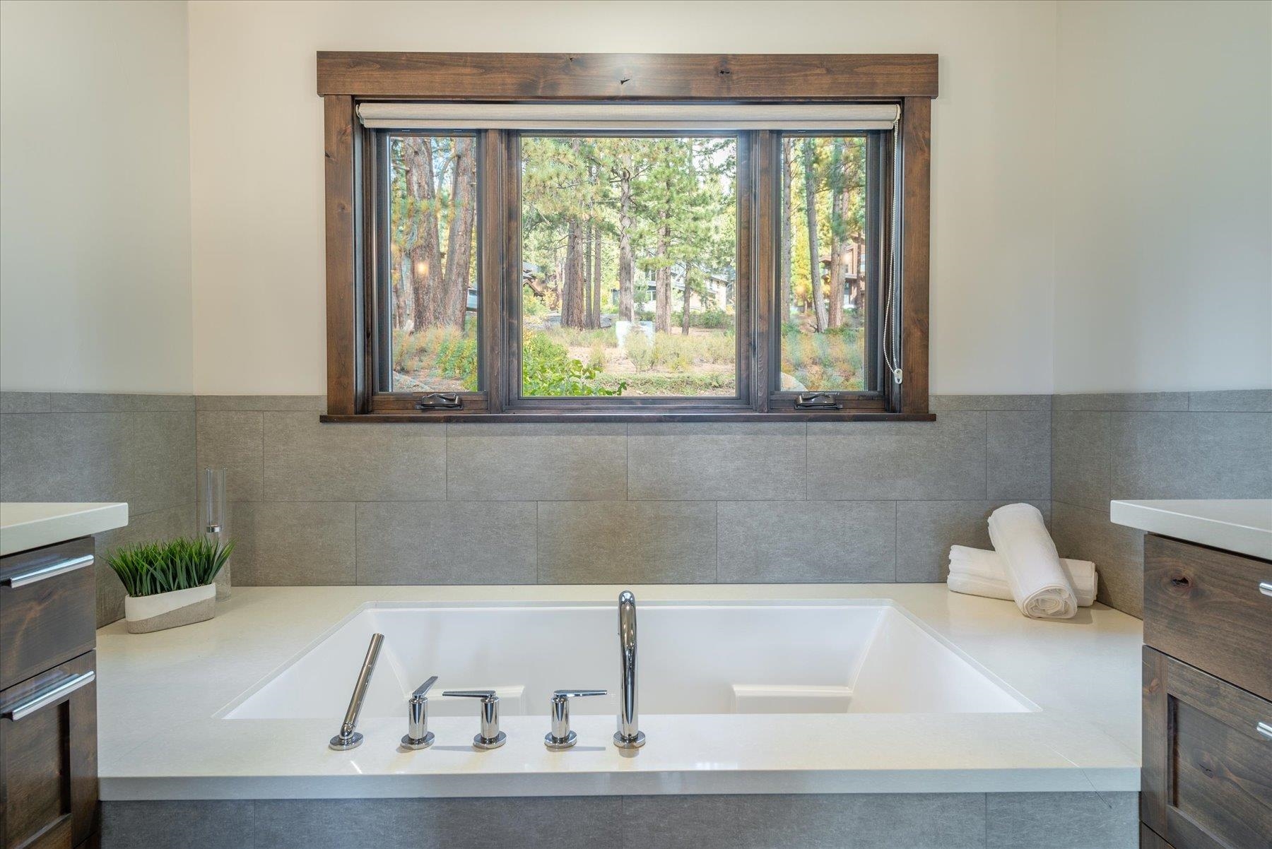 11460 Ghirard Road Truckee, CA 96161 - Photo 11 of 21 a white bath tub sitting in a bathroom next to a window