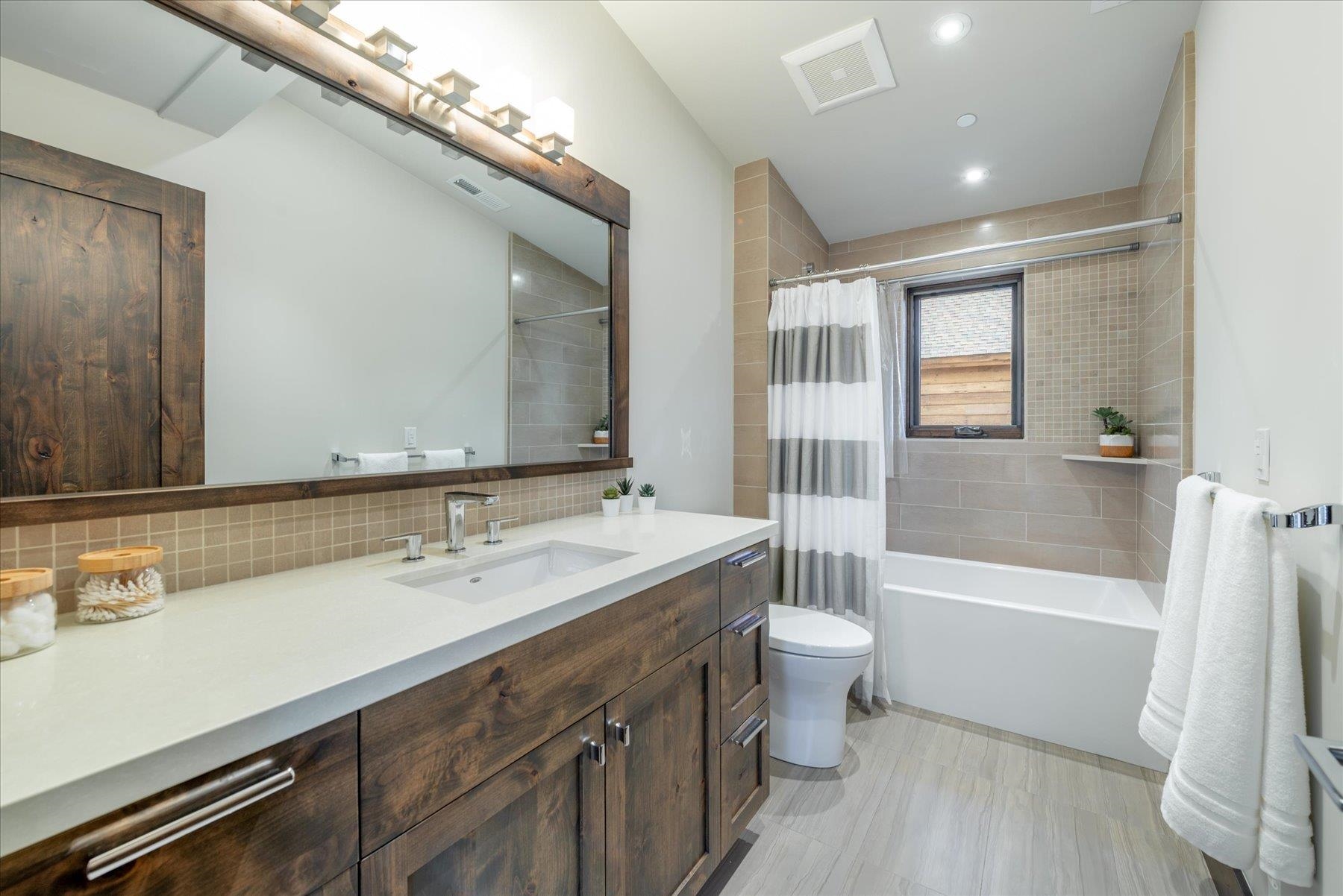 11460 Ghirard Road Truckee, CA 96161 - Photo 14 of 21 a bathroom with a sink a toilet a mirror and shower