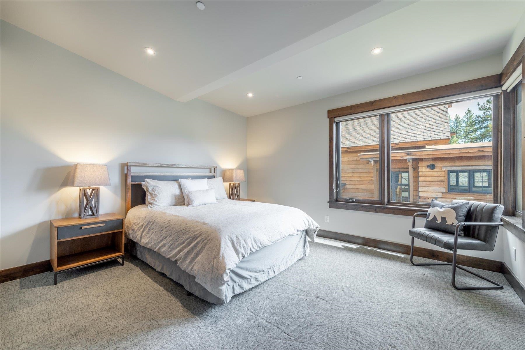 11460 Ghirard Road Truckee, CA 96161 - Photo 15 of 21 a spacious bedroom with a bed and a window