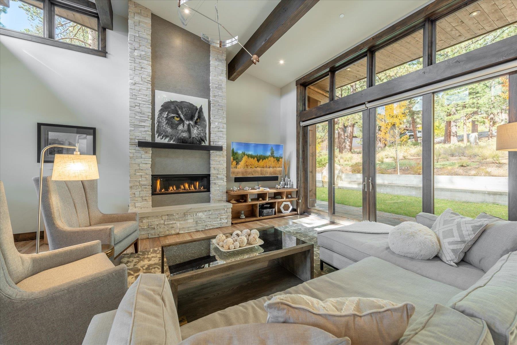 11460 Ghirard Road Truckee, CA 96161 - Photo 4 of 21 a living room with furniture large window and a fireplace