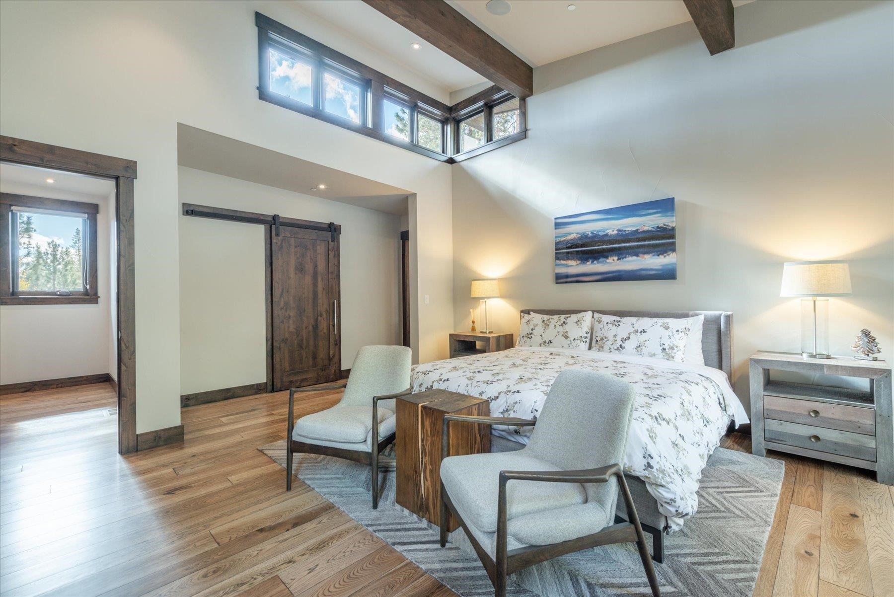 11460 Ghirard Road Truckee, CA 96161 - Photo 9 of 21 a bedroom with a bed and a chandelier