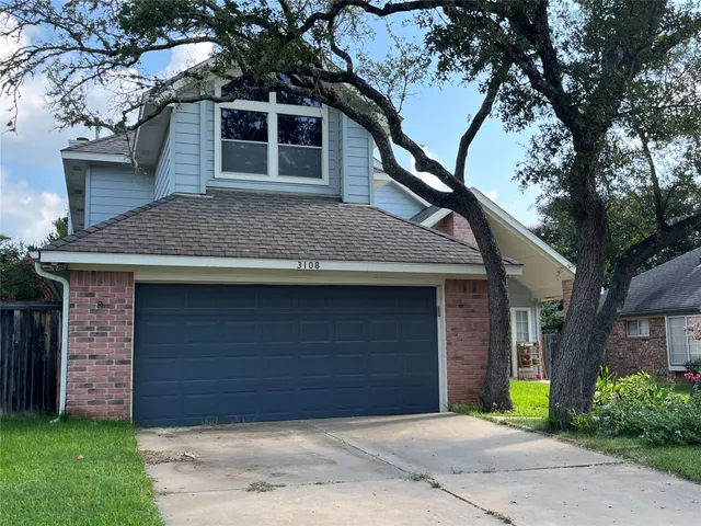 a house that has a tree in front of the house
