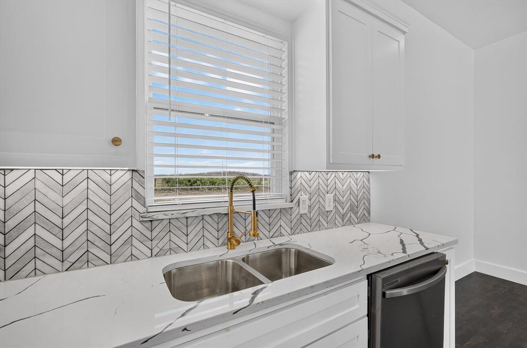 102 Shadywood Road Trinidad, TX 75163 - Photo 11 of 24 Kitchen sink area featuring a dual stainless steel sink with a gold-tone gooseneck faucet