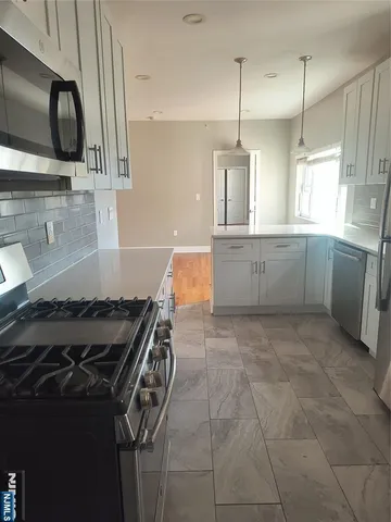 a kitchen with a stove a sink and a microwave