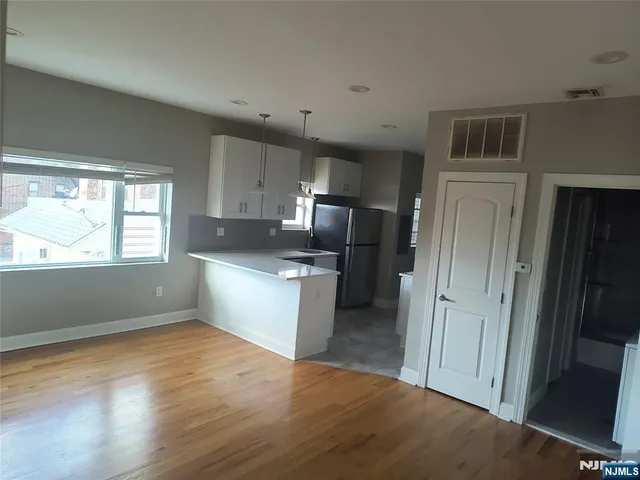 a kitchen with a refrigerator and a stove top oven