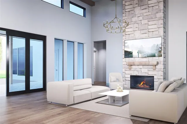 a living room with furniture a fireplace and a chandelier