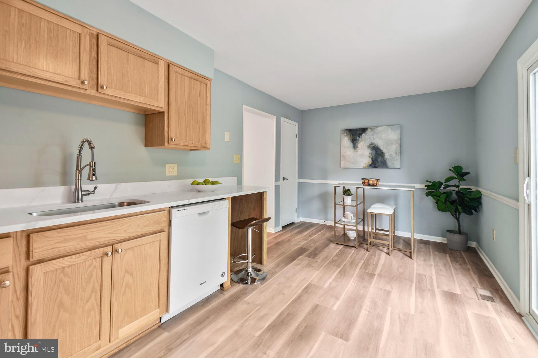 2895 Schoolhouse Circle Silver Spring, MD 20902 - Photo 13 of 33 a kitchen with a sink cabinets and window