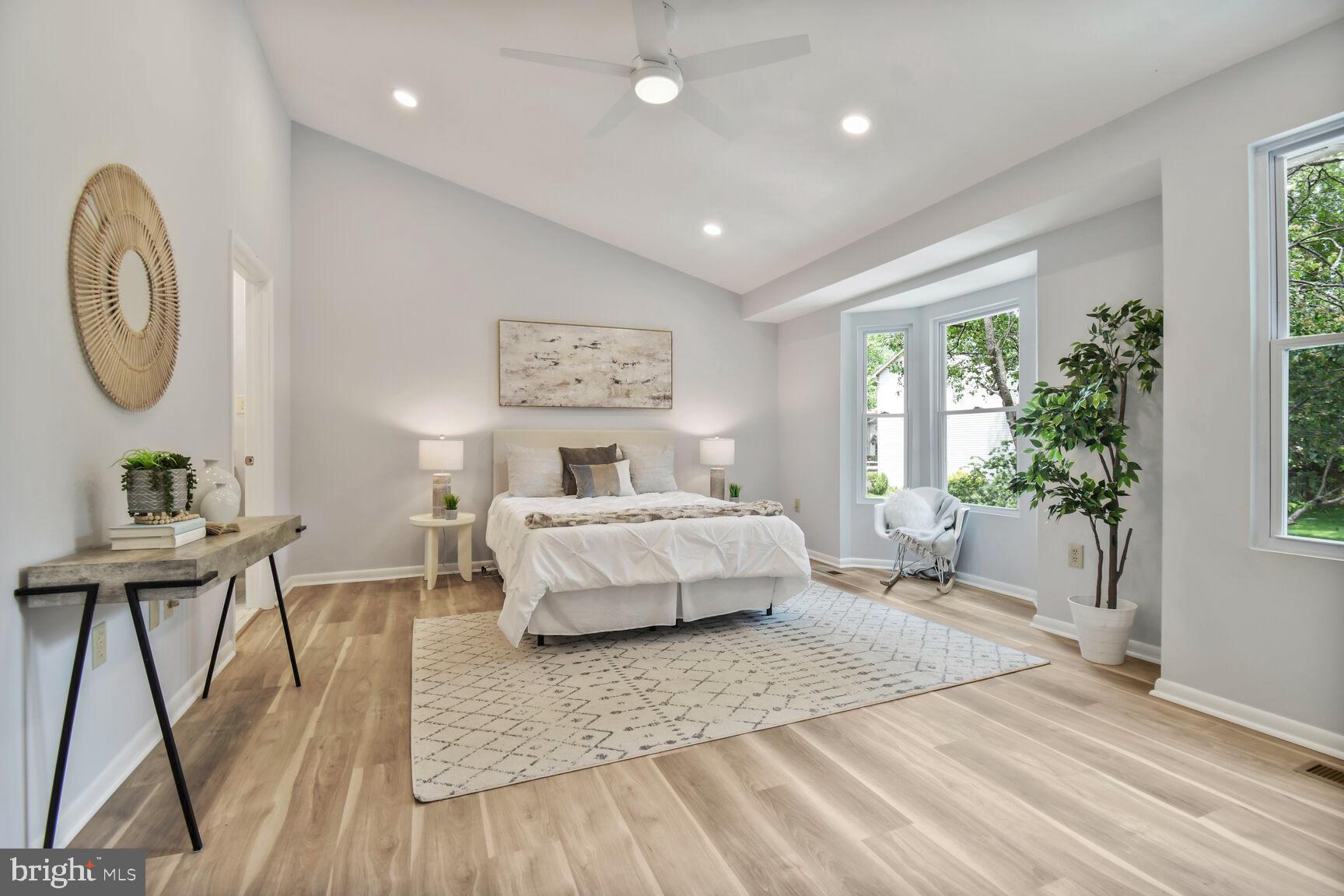 2895 Schoolhouse Circle Silver Spring, MD 20902 - Photo 14 of 33 a spacious bedroom with a large bed and a chandelier