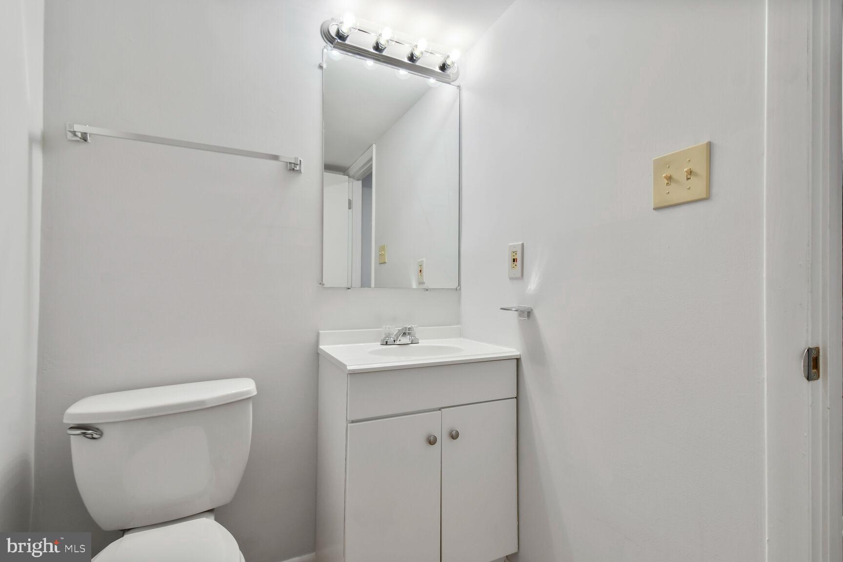 2895 Schoolhouse Circle Silver Spring, MD 20902 - Photo 27 of 33 a bathroom with a toilet sink and mirror