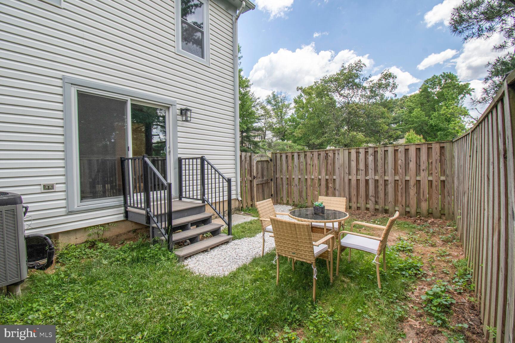 2895 Schoolhouse Circle Silver Spring, MD 20902 - Photo 29 of 33 a view of a chair and table in backyard of the house