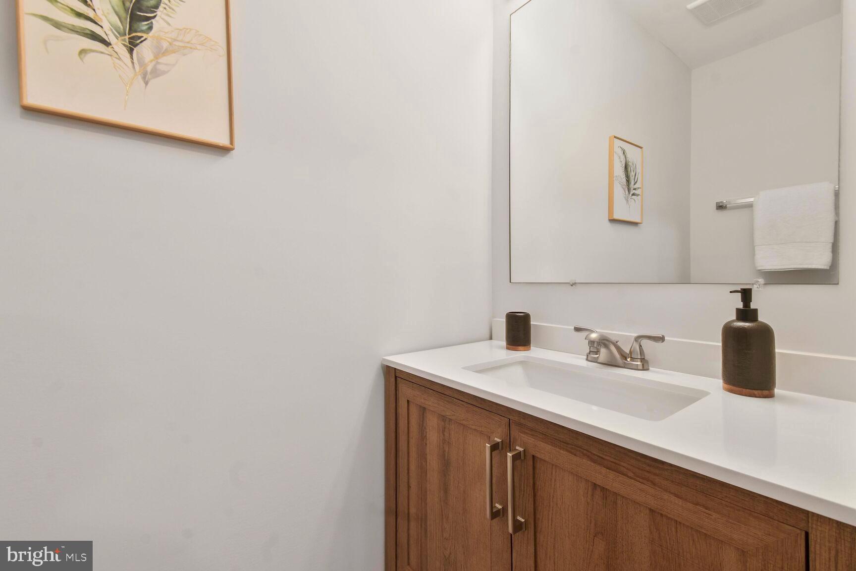 2895 Schoolhouse Circle Silver Spring, MD 20902 - Photo 8 of 33 a bathroom with a sink and a mirror