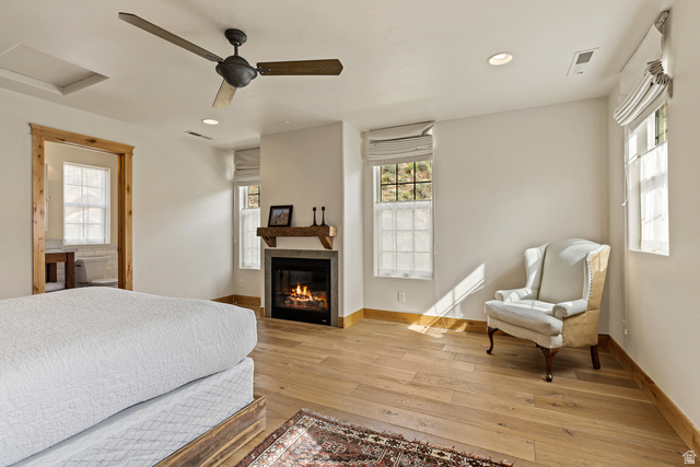105 River Bend Circle, Unit 105 Springdale, UT 84767 - Photo 28 of 56 Bedroom featuring light wood-finish flooring, a ceiling fan, recessed lighting, and a fireplace with a wood mantle