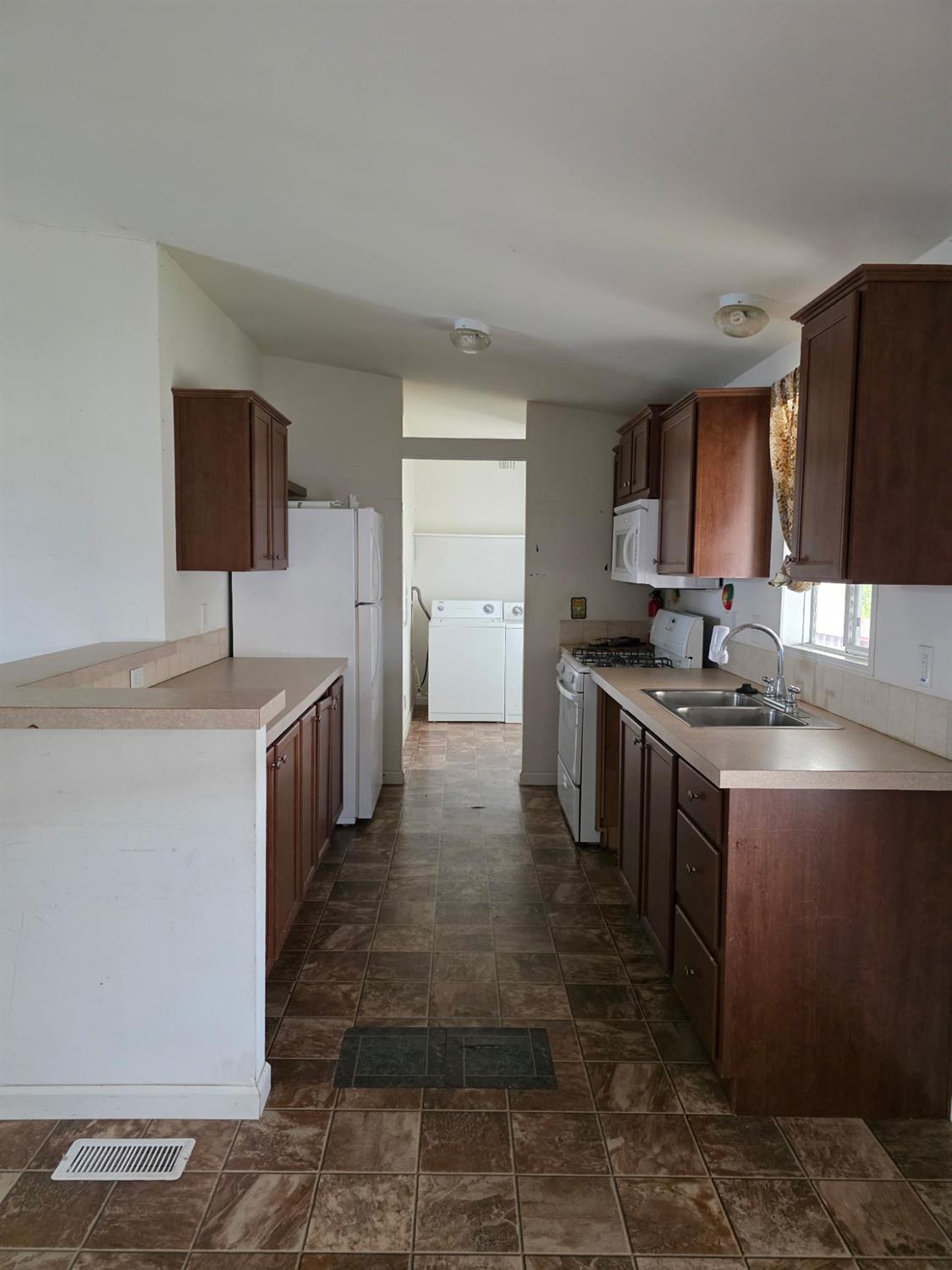 3901 Lake Road, Unit 29 West Sacramento, CA 95691 - Photo 6 of 15 a kitchen with stainless steel appliances granite countertop a sink stove and refrigerator