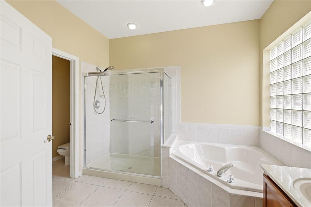 936 Kingsridge Circle Gotha, FL 34734 - Photo 12 of 50 a bathroom with a tub shower and sink