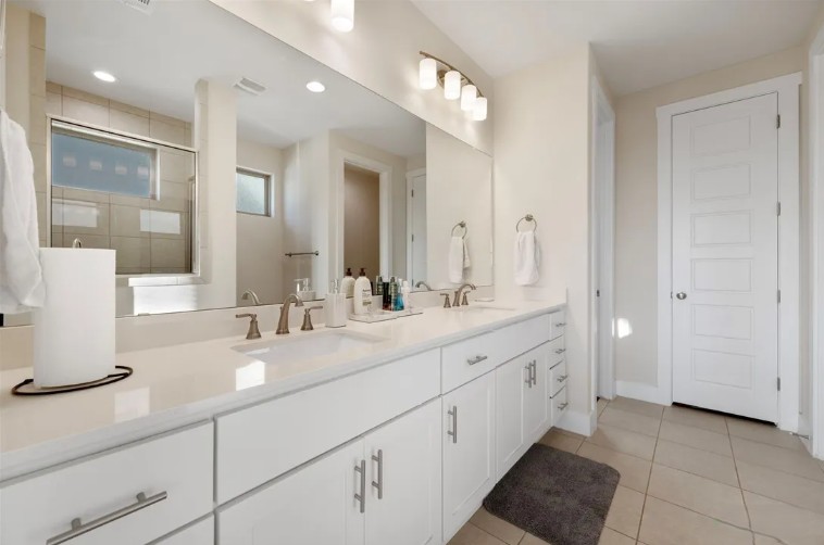 344 Pisa Lane Georgetown, TX 78628 - Photo 25 of 39 Clean lines and a generous double vanity anchor this modern, light-filled bathroom space.