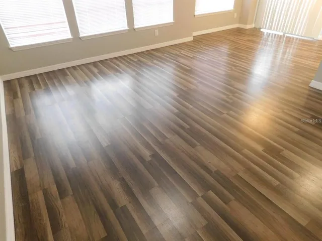 a view of an empty room and wooden floor