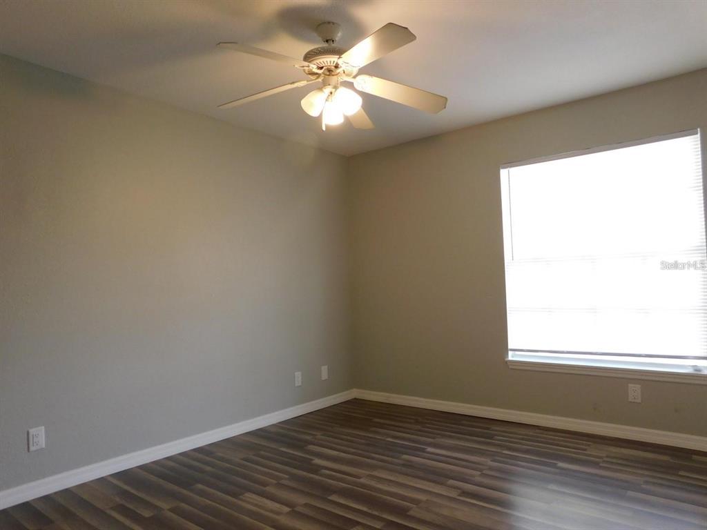 1077 South Hiawassee Road, Unit 823 Orlando, FL 32835 - Photo 12 of 29 wooden floor in an empty room with a window