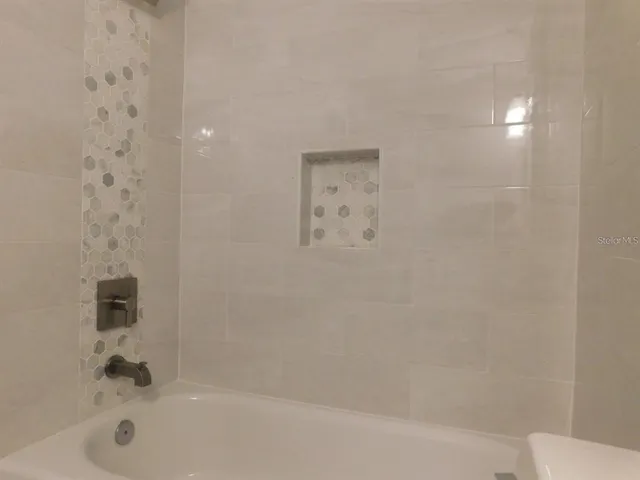 a bathroom with a bathtub and shower