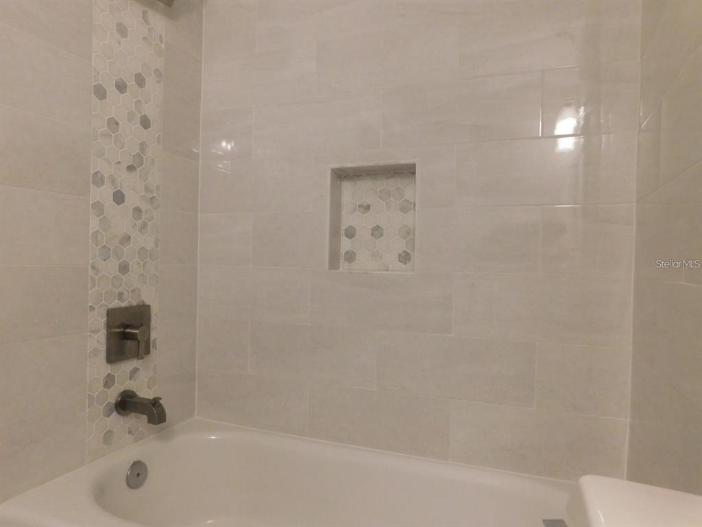 1077 South Hiawassee Road, Unit 823 Orlando, FL 32835 - Photo 17 of 29 a bathroom with a bathtub and shower