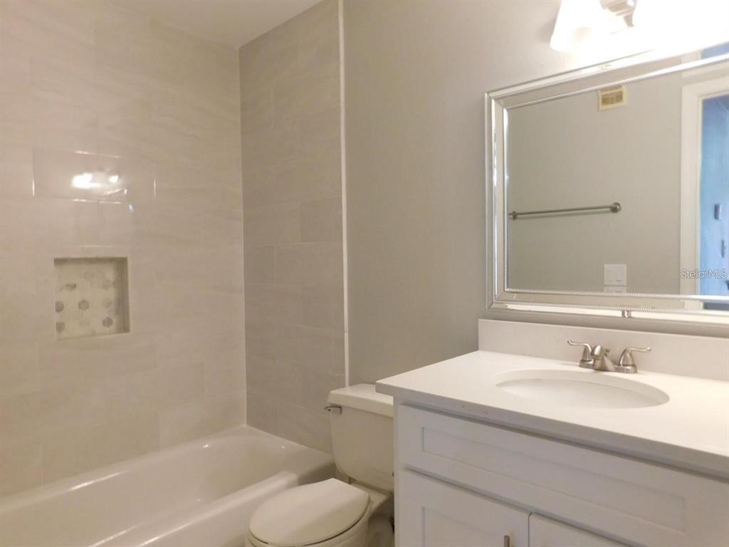 1077 South Hiawassee Road, Unit 823 Orlando, FL 32835 - Photo 18 of 29 a bathroom with a sink toilet and shower