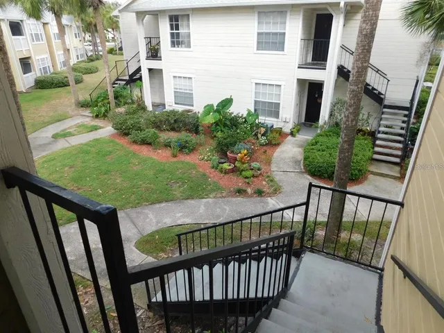 a view of a porch with wooden floor and fence