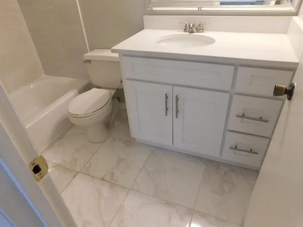 a bathroom with a sink toilet and vanity