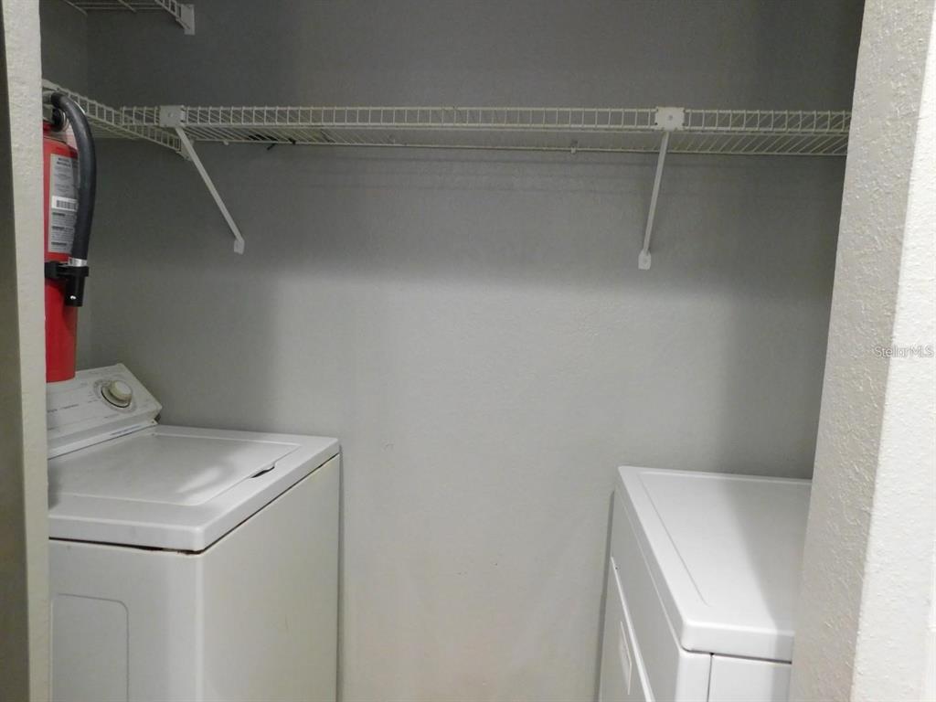 1077 South Hiawassee Road, Unit 823 Orlando, FL 32835 - Photo 25 of 29 a utility room with dryer and washer