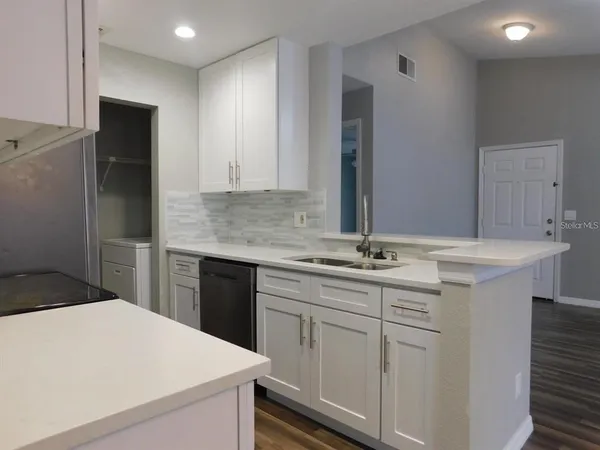 a kitchen with a sink and cabinets