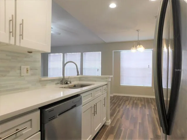 a kitchen with a sink and outdoor space
