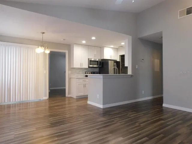 a view of a kitchen with wooden floor and a kitchen