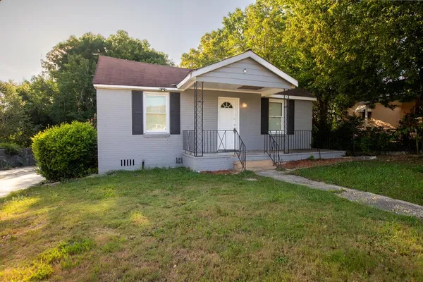 a front view of a house with a yard and porch