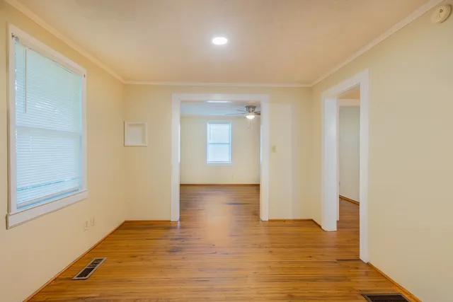 a view of hallway with wooden floor