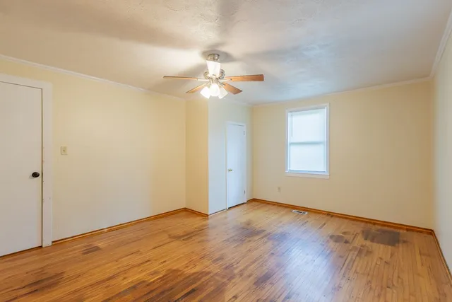 wooden floor in an empty room with a window