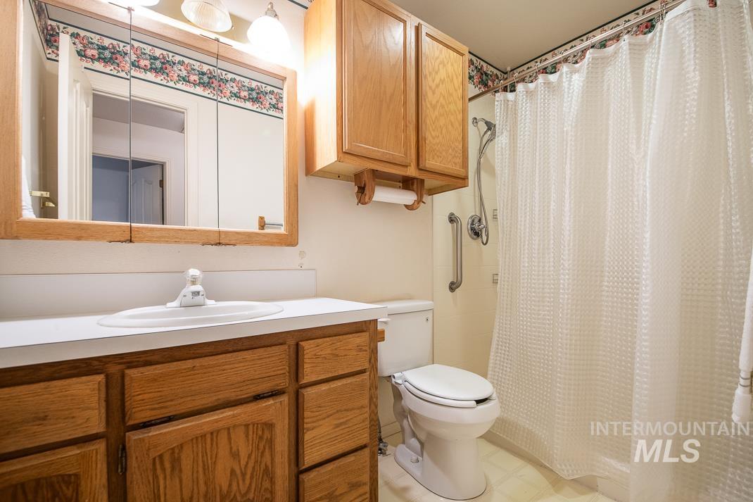 16517 Madison Road Nampa, ID 83687 - Photo 16 of 26 Bathroom with a shower with curtain, vanity, and light floors