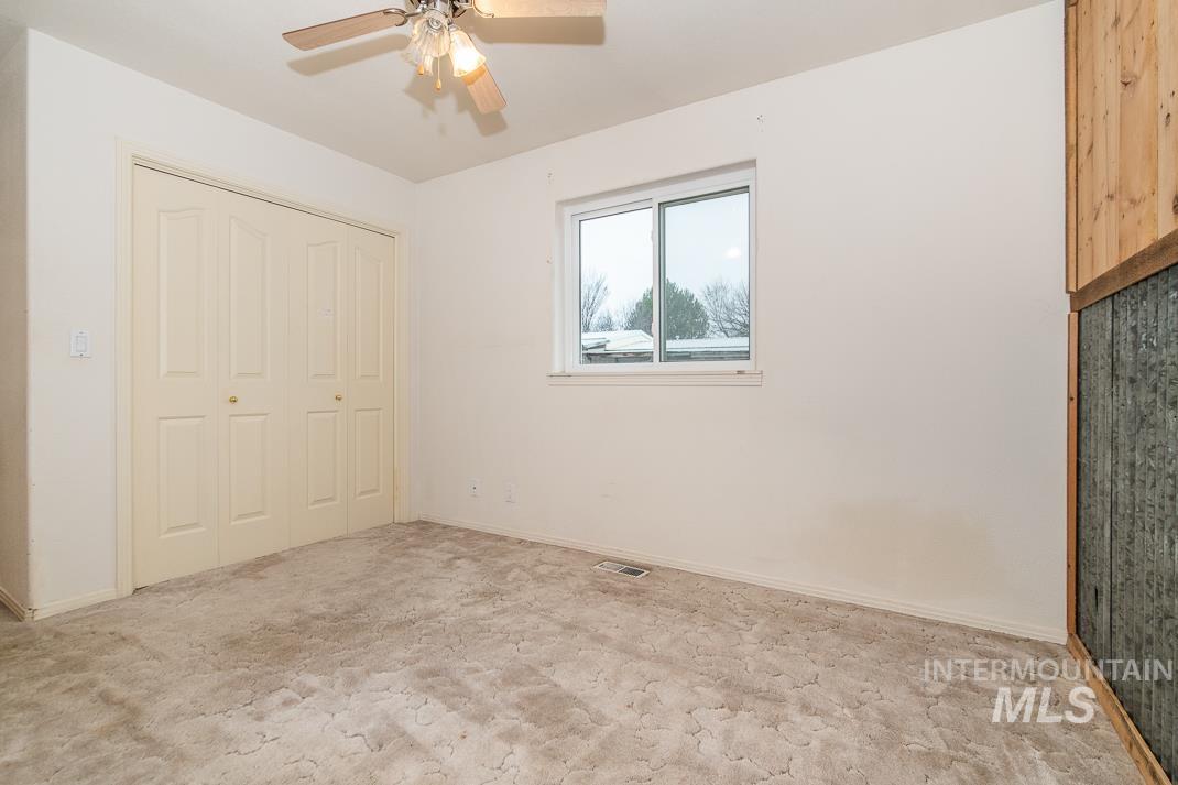 16517 Madison Road Nampa, ID 83687 - Photo 17 of 26 Unfurnished bedroom featuring ceiling fan and a closet