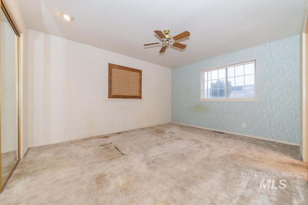 16517 Madison Road Nampa, ID 83687 - Photo 20 of 26 Spare room with wallpapered walls and ceiling fan