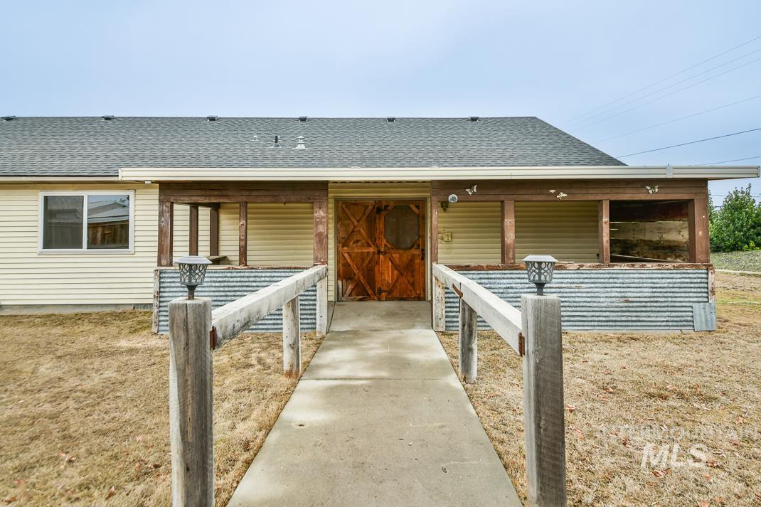 16517 Madison Road Nampa, ID 83687 - Photo 25 of 26 Doorway to property with a shingled roof and a patio area