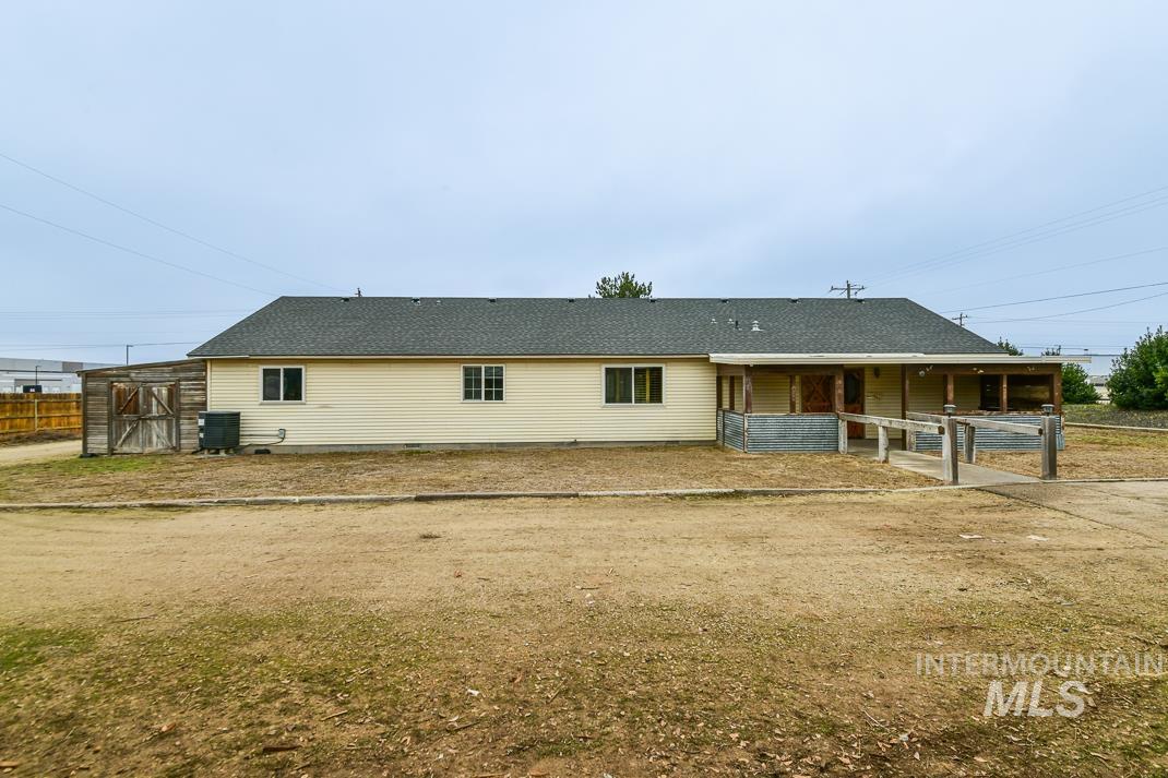 16517 Madison Road Nampa, ID 83687 - Photo 26 of 26 Rear view of property featuring an outdoor structure, roof with shingles, and a patio