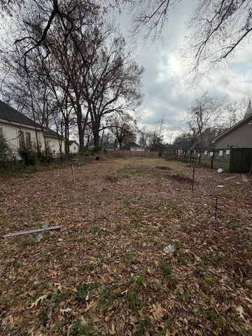 a view of a backyard with large trees