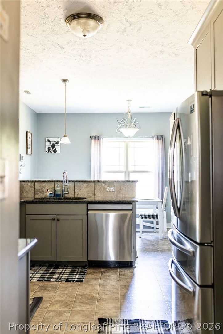 210 McGougan Road Lumber Bridge, NC 28357 - Photo 15 of 47 a kitchen with stainless steel appliances granite countertop a refrigerator and a sink