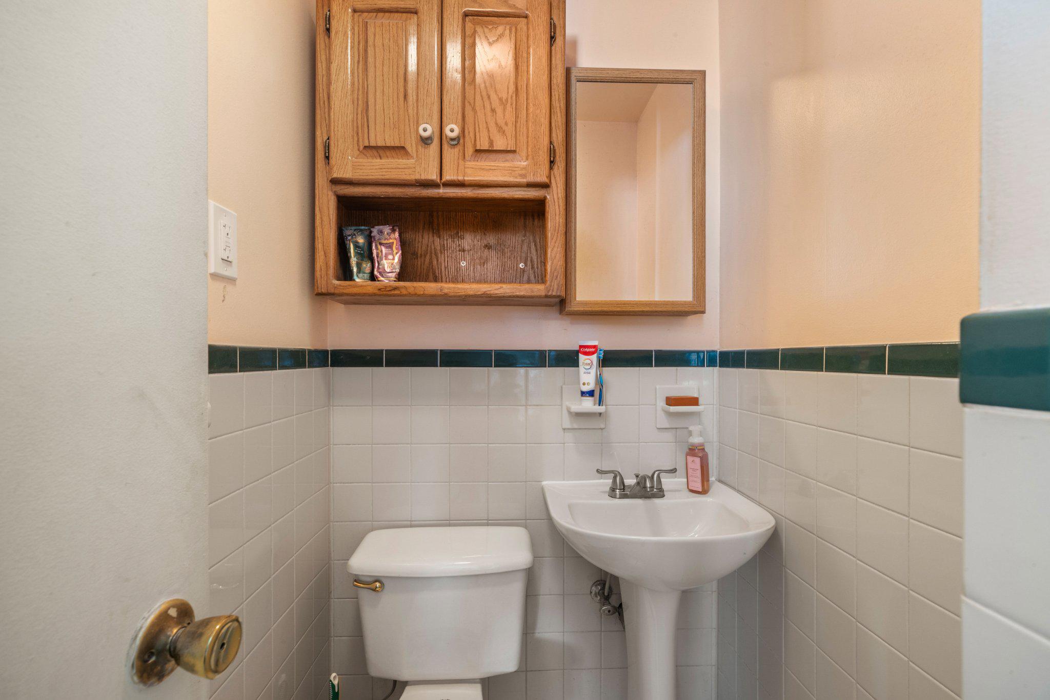 5620 Chelwynd Road Halethorpe, MD 21227 - Photo 13 of 22 a bathroom with a sink a toilet and mirror