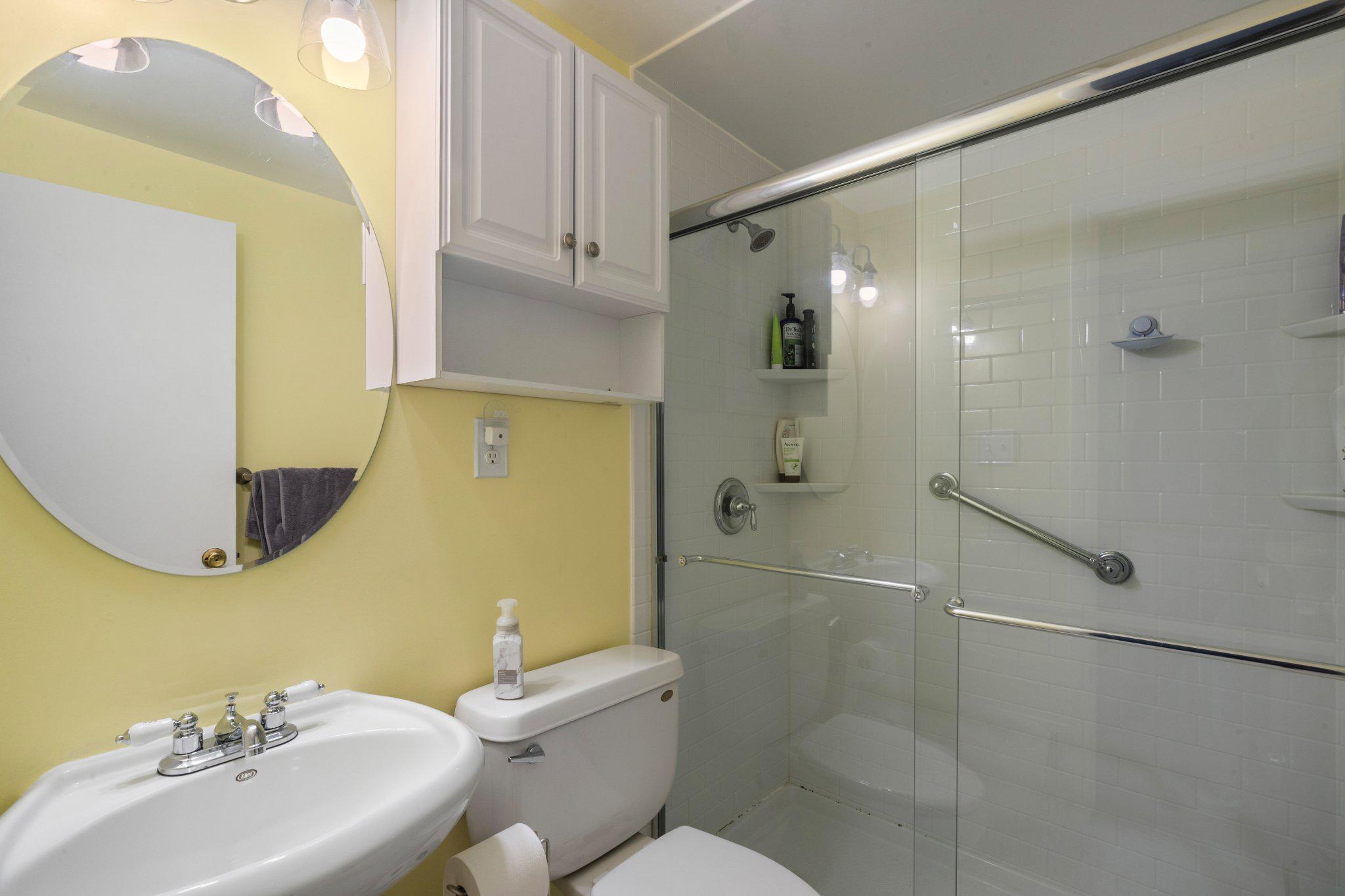 5620 Chelwynd Road Halethorpe, MD 21227 - Photo 15 of 22 a bathroom with a sink mirror toilet and shower