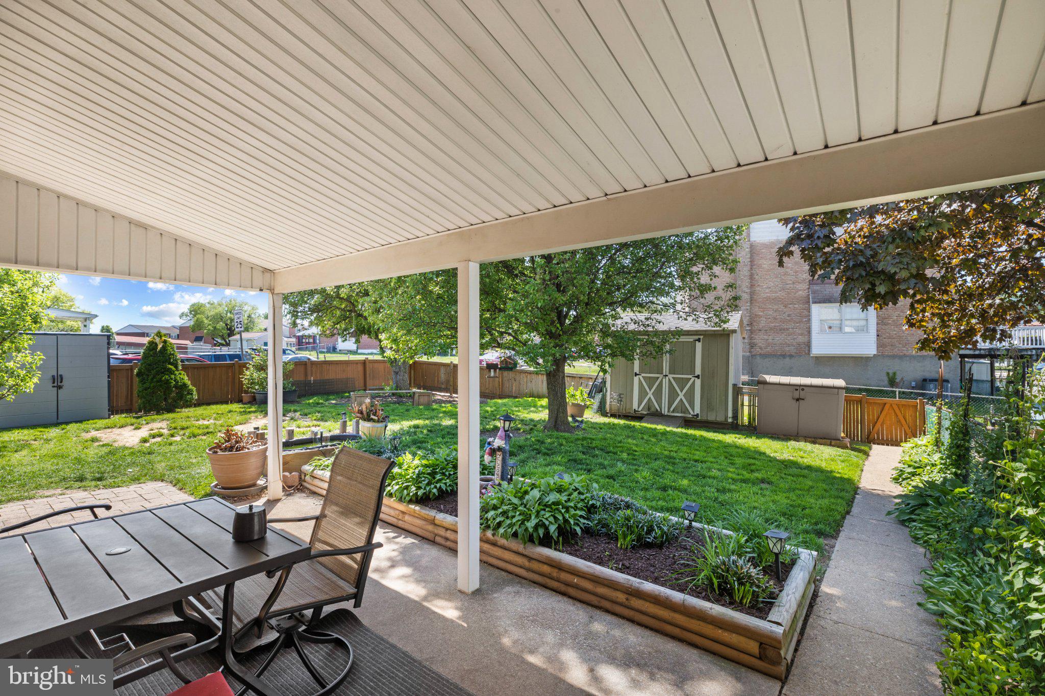 5620 Chelwynd Road Halethorpe, MD 21227 - Photo 17 of 22 a view of a patio with table and chairs potted plants with floor to ceiling window